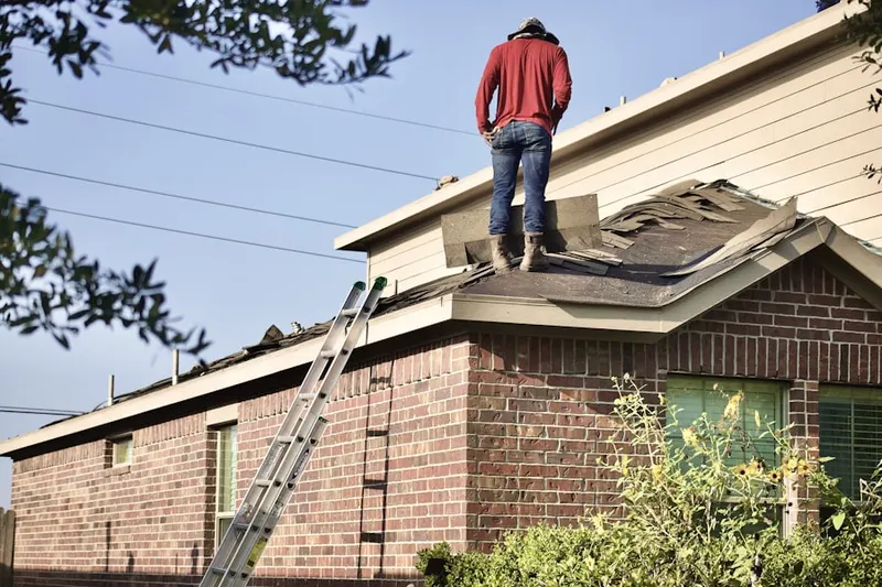 Professional roofer working on a residential roof in Reflection Ridge